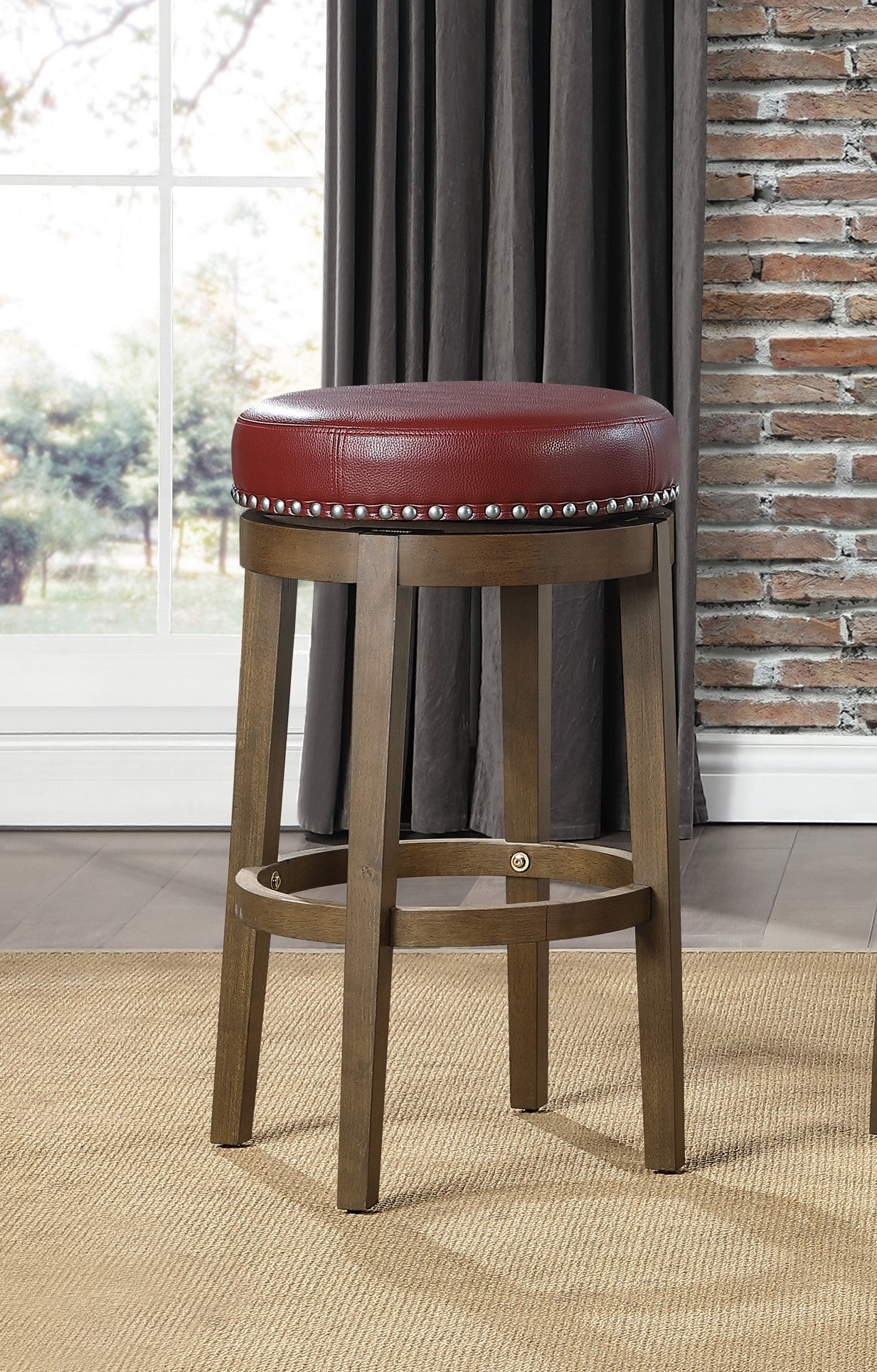 Round tufted red leather bar stool with nailhead trim and wooden legs
