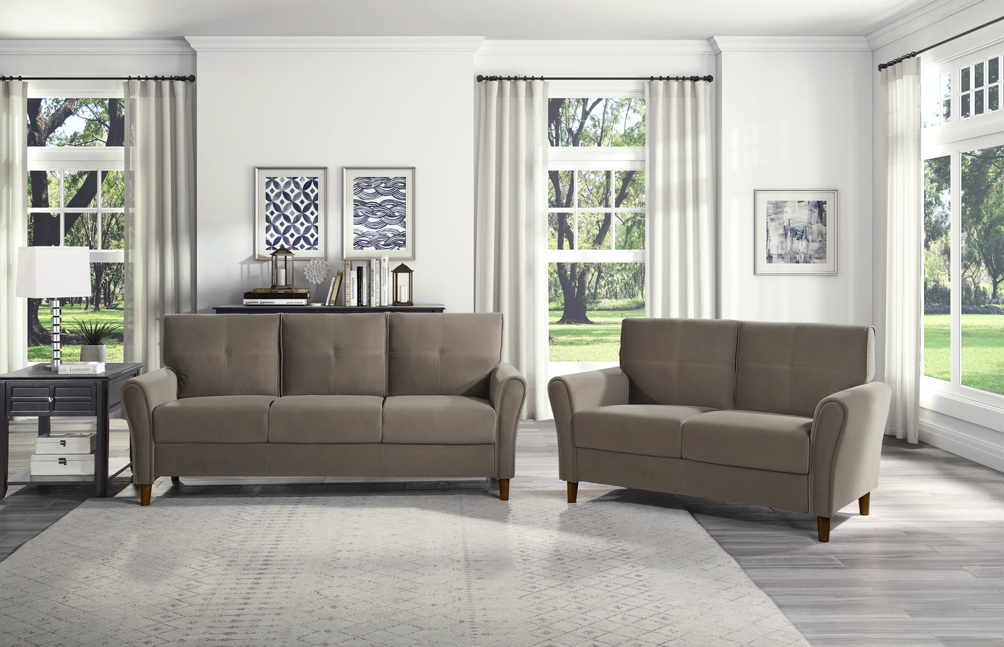 Taupe upholstered sofa with tufted cushions and a matching loveseat in a bright living room setting