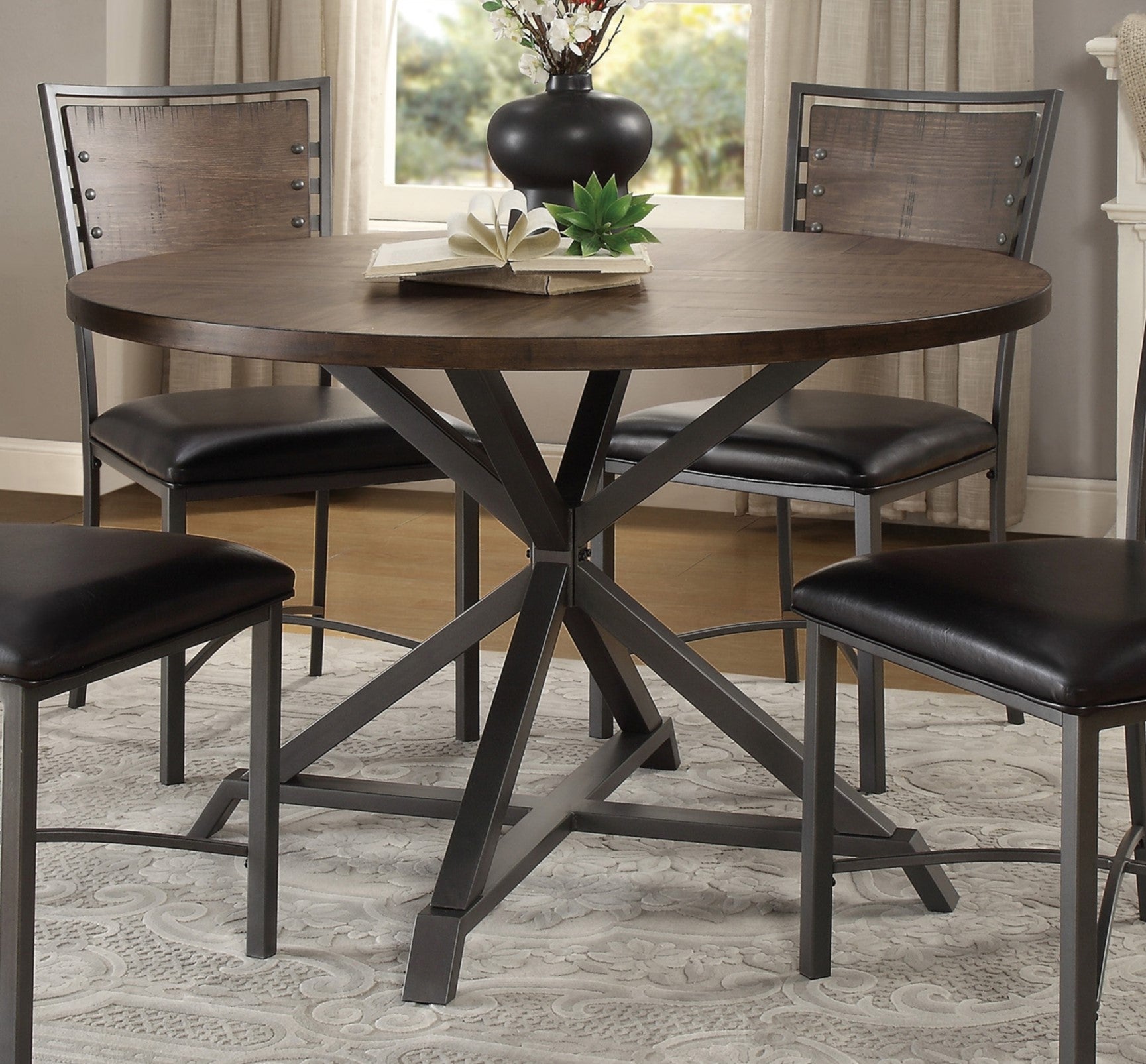 Round industrial dining table with dark wood top and metal base