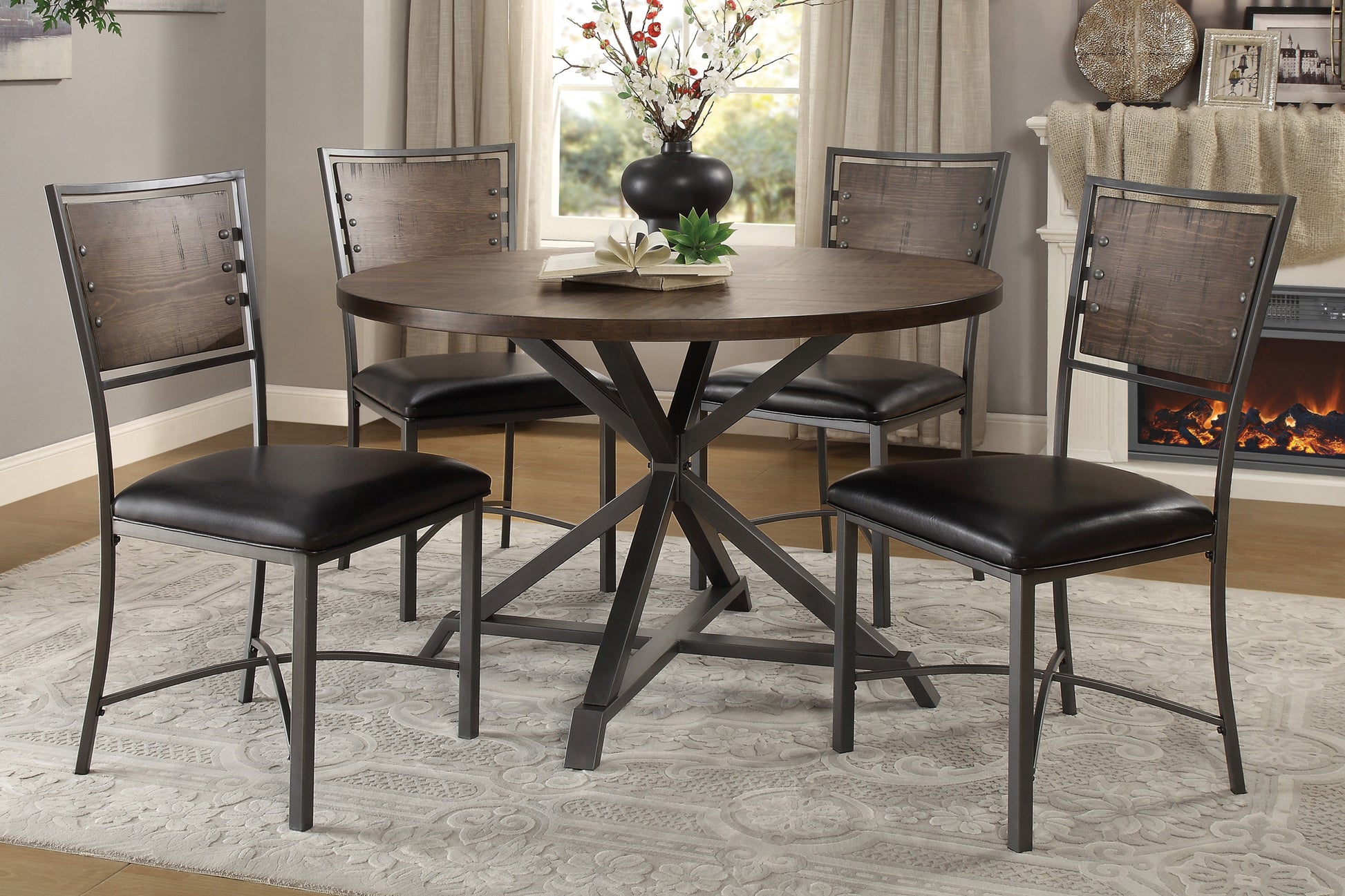 Rustic oak and metal round dining table with four black leather chairs and industrial design