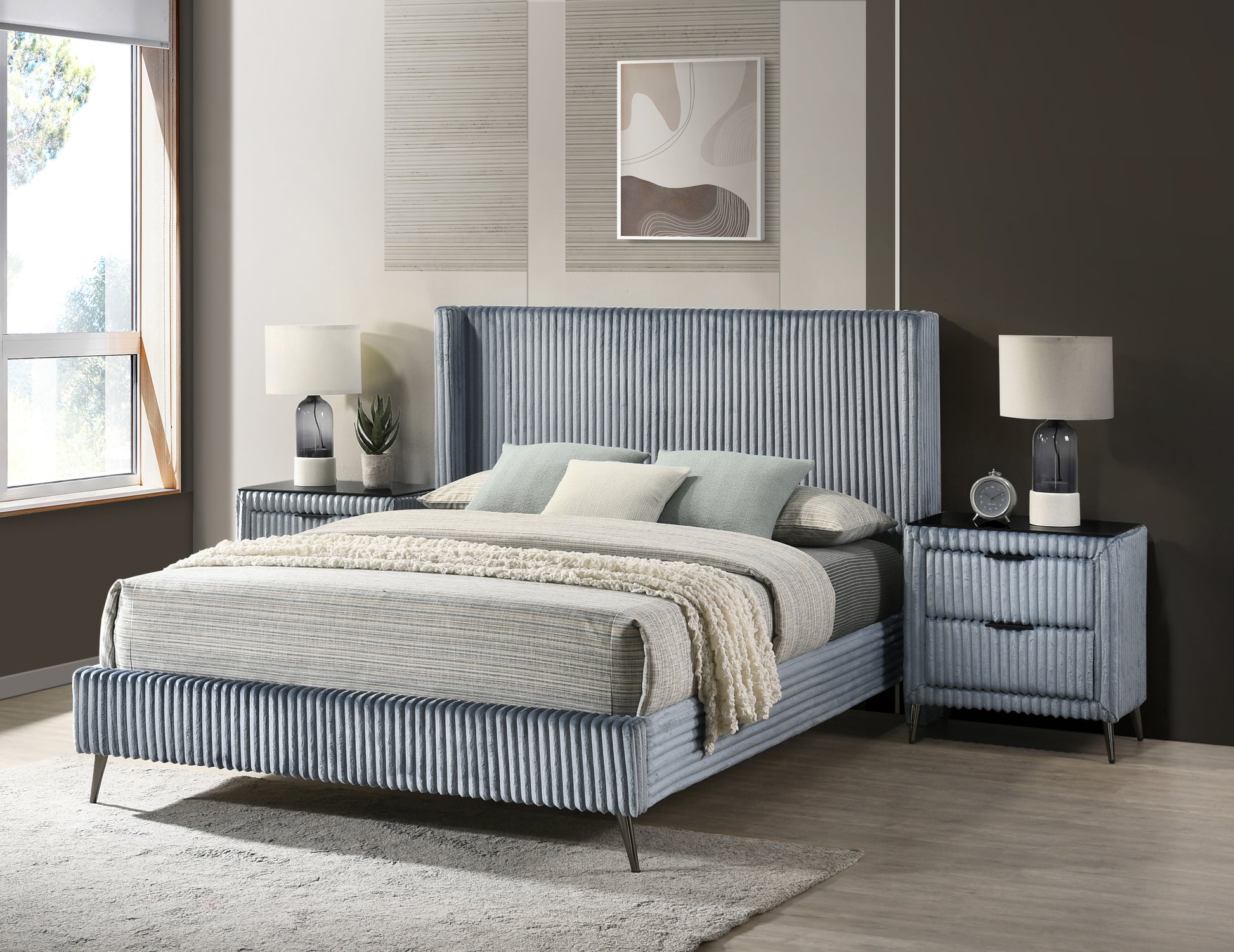 Blue velvet upholstered bed with ribbed headboard and matching nightstands