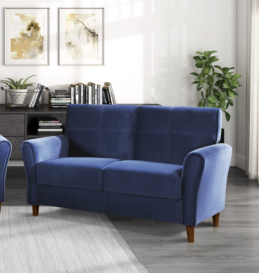 Deep blue velvet loveseat with cushioned tufted back and rolled arms