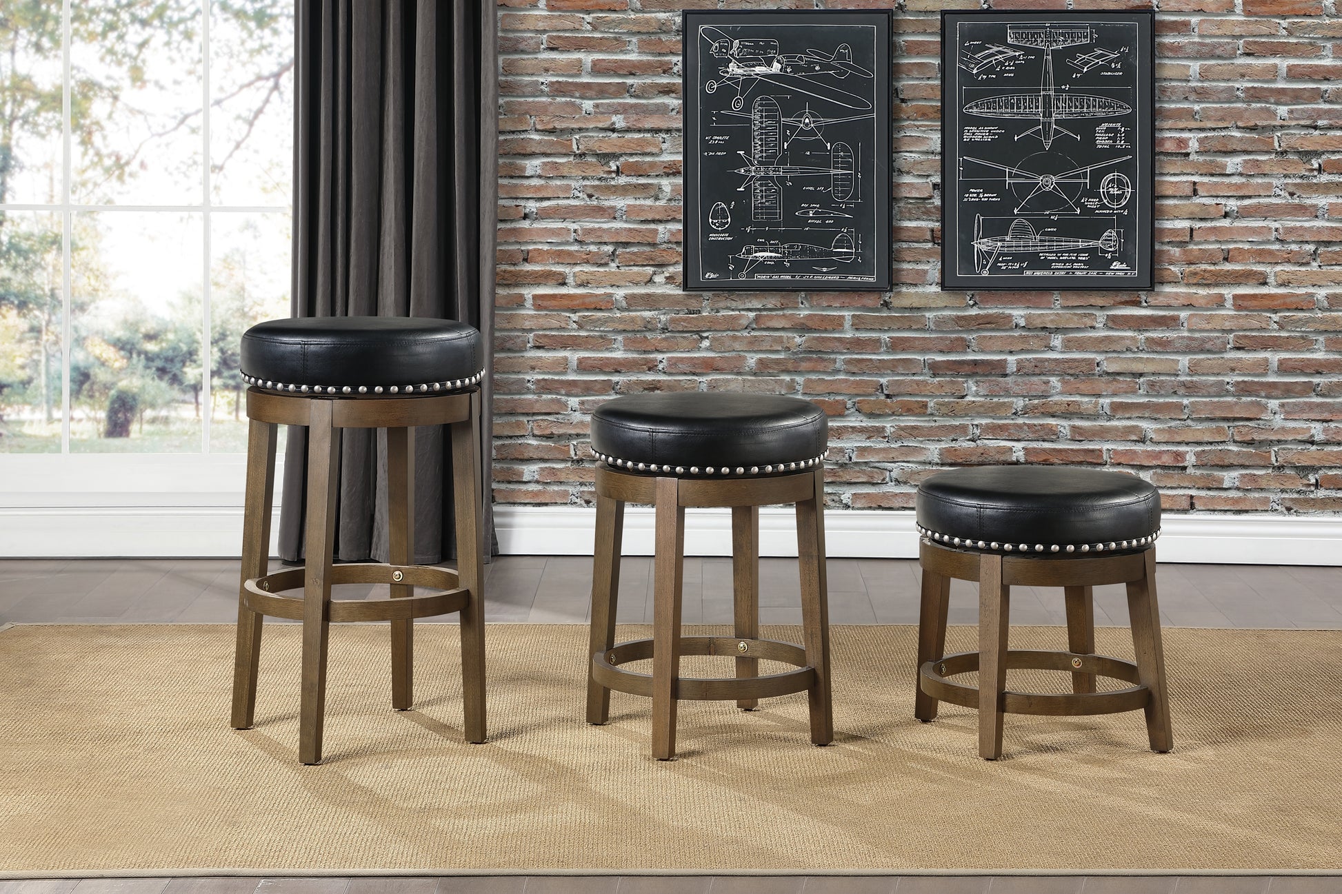 Three modern bar stools with black leather seats and silver nailhead trim