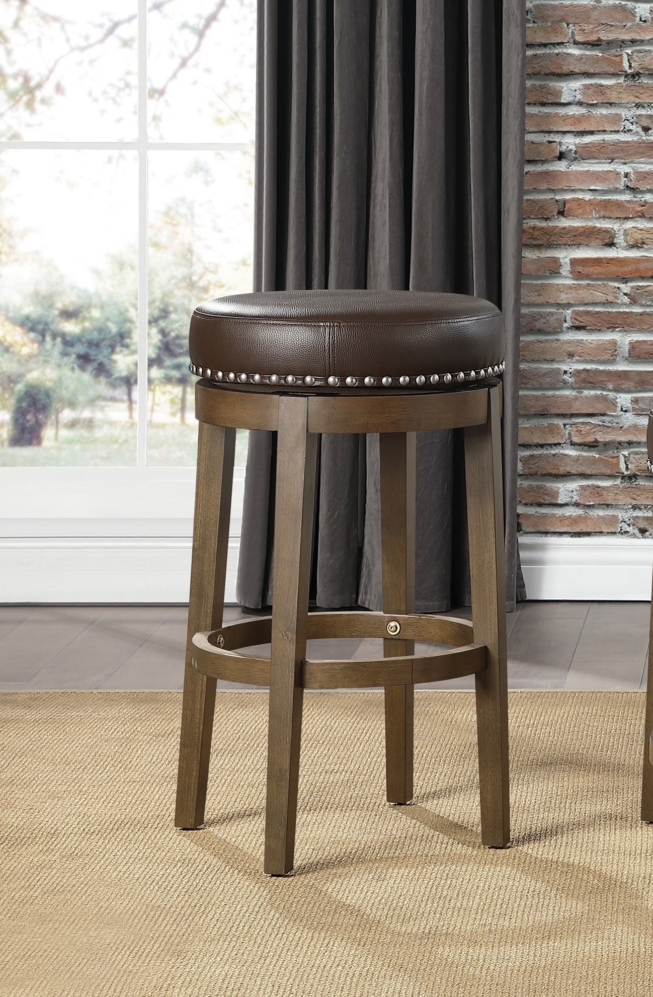 Brown leather swivel bar stool with silver nailhead trim and wooden legs