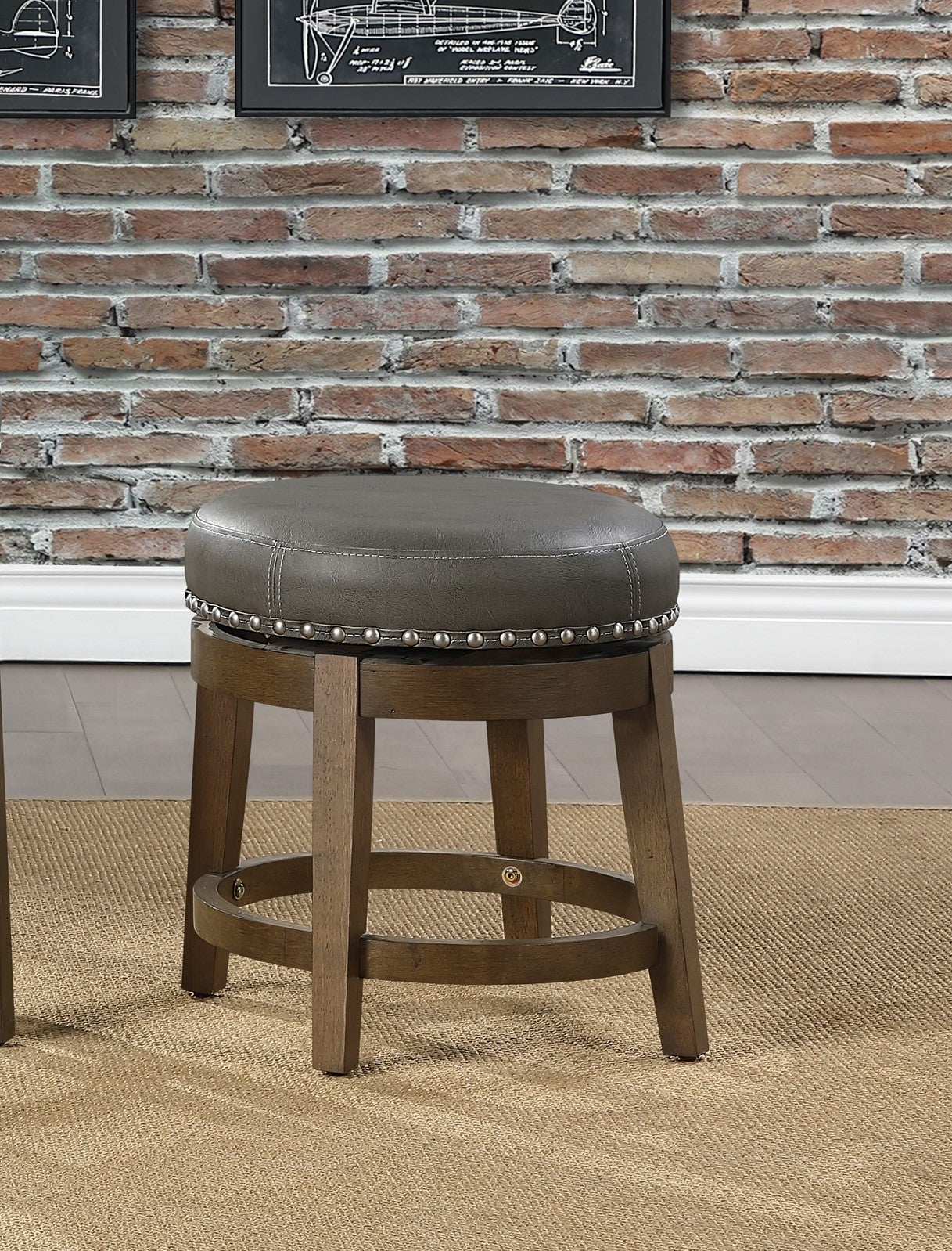 Round grey faux leather swivel bar stool with nailhead trim and wooden legs