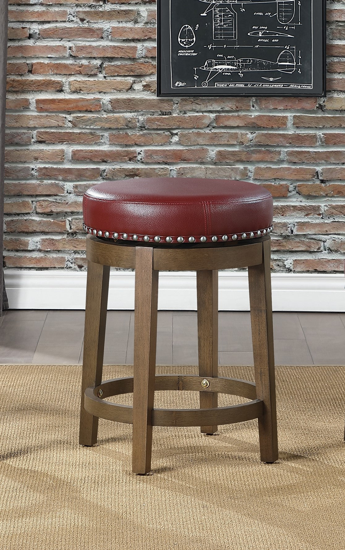 Round red leather swivel bar stool with silver nailhead trim and wooden legs