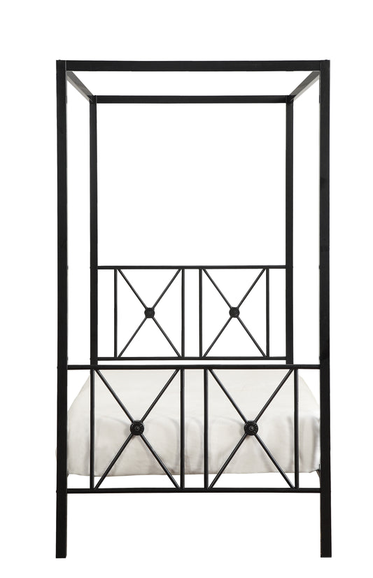 Black metal fourposter bed frame with white duvet featuring geometric headboard detail