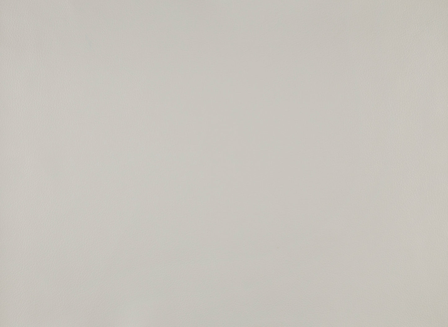 Closeup of smooth light grey faux leather fabric texture with subtle grain