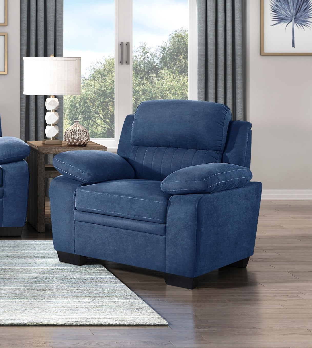 Deep blue plush recliner chair with padded arms and headrest