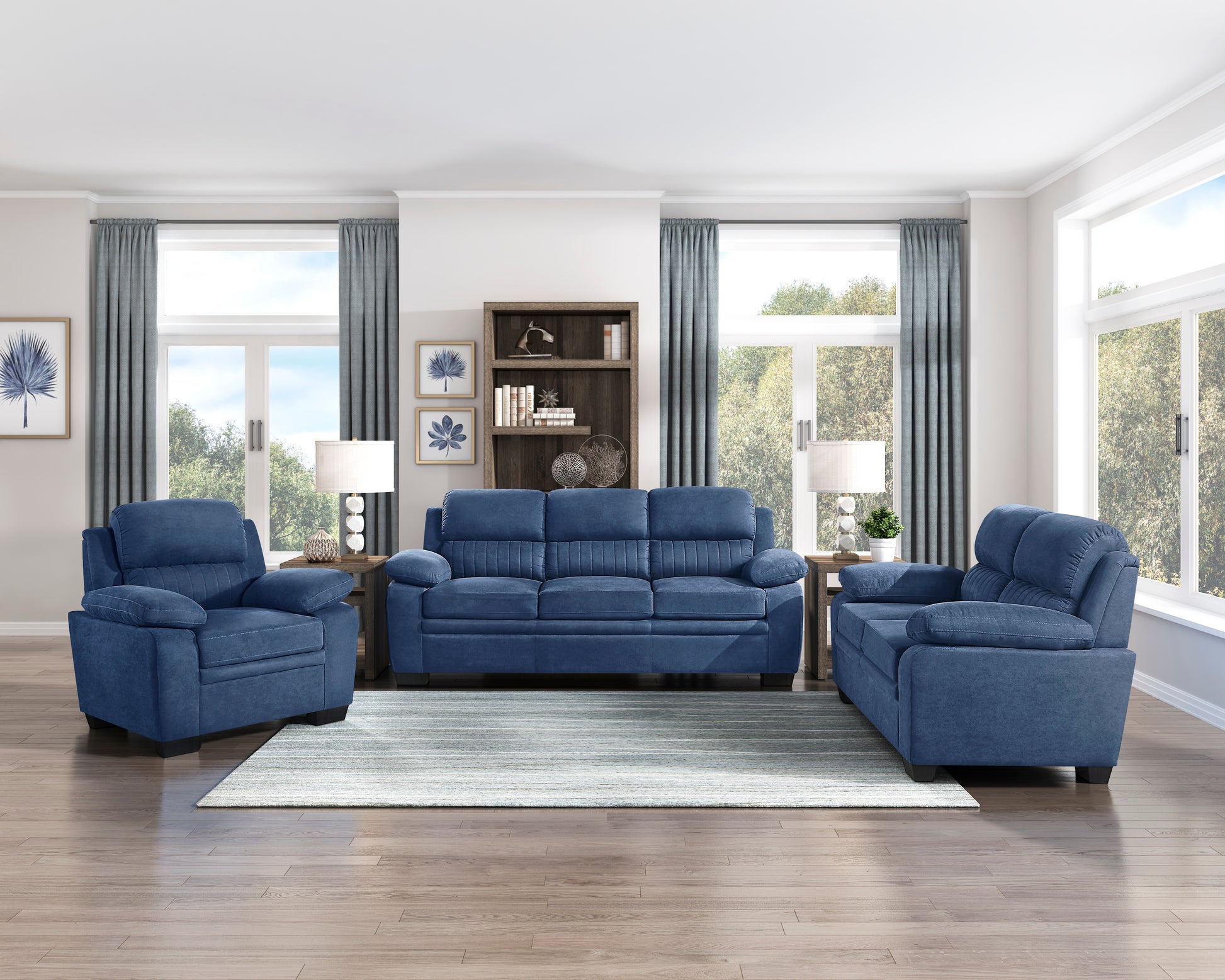 Threepiece navy blue upholstered living room set with sofa and two armchairs on a striped rug