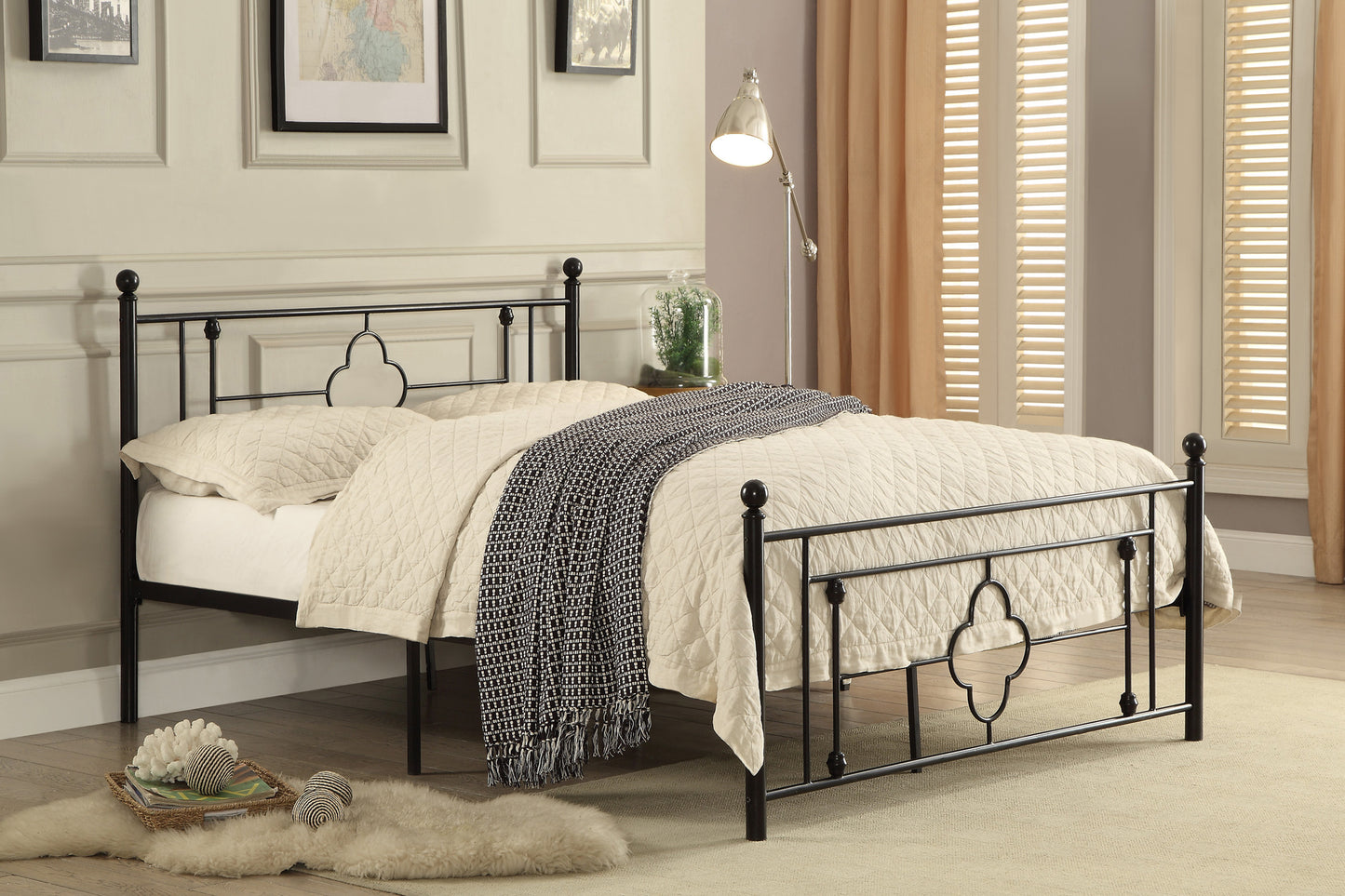 Black metal queen bed frame with ornamental scrollwork and white quilted bedding