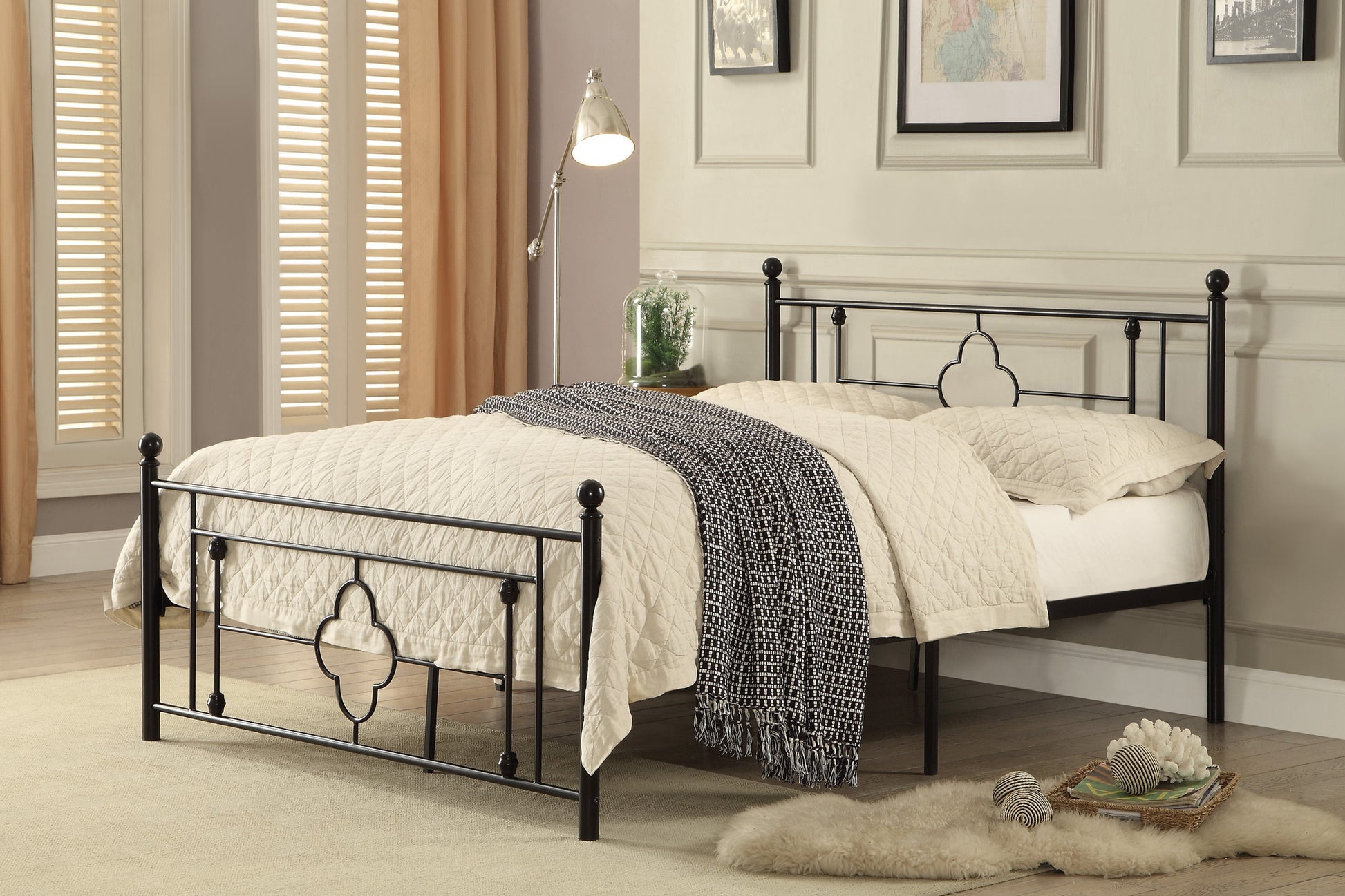 Black metal twin bed frame with decorative finials and quatrefoil accents