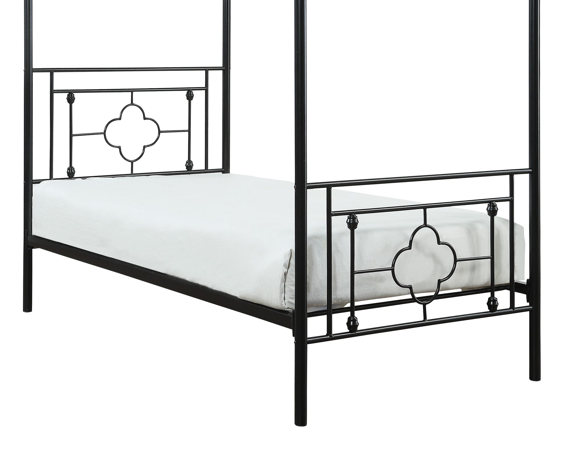 Black metal canopy bed frame with quatrefoil accents and white mattress
