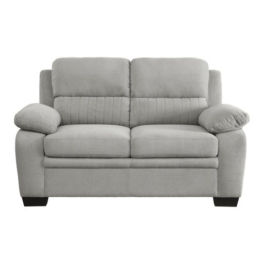 Light gray fabric loveseat with tufted back cushions and plush armrests