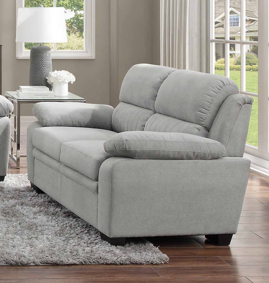 Plush gray fabric loveseat with rolled arms and deep seat cushions perfect for a cozy living room