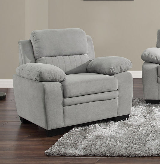 Plush grey upholstered armchair with padded arms and adjustable headrest