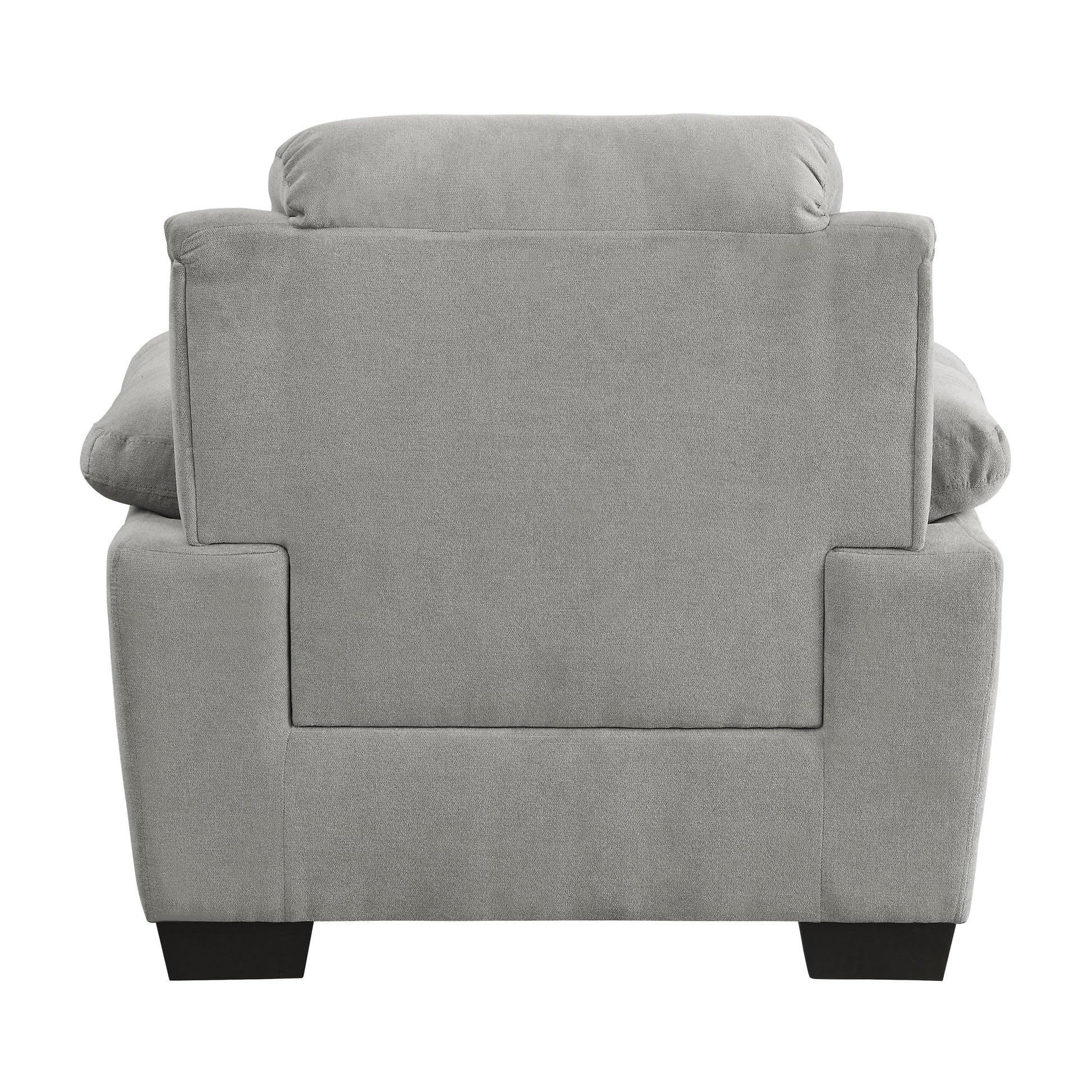 Rear view of a plush gray fabric armchair with a square back and padded headrest