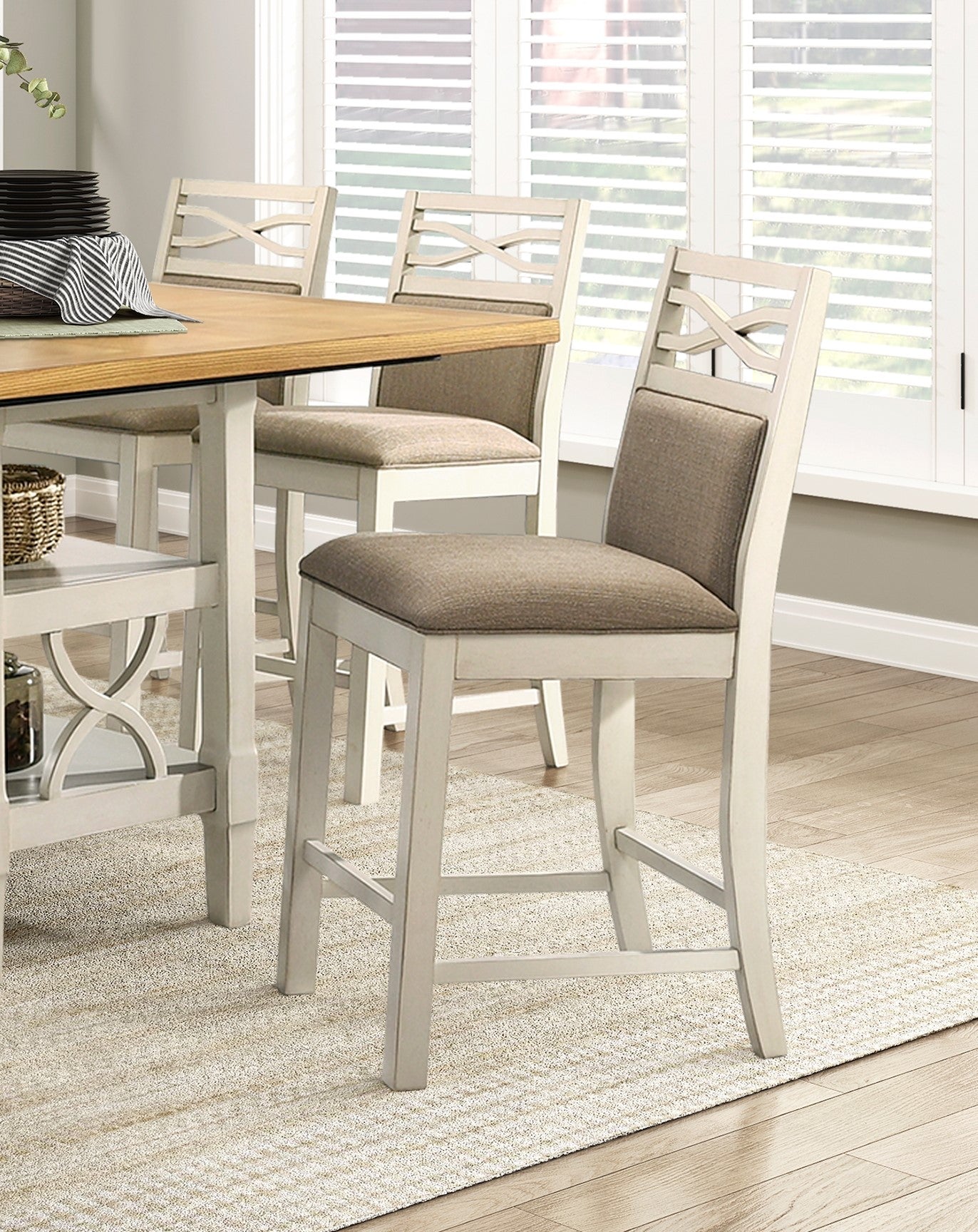 Cream upholstered bar stool with elegant crisscross back detail and white frame