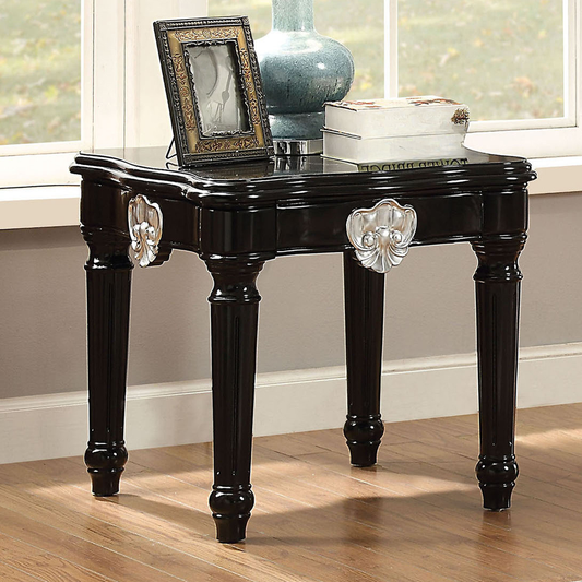 Elegant black accent table with ornate silver drawer pulls and fluted legs