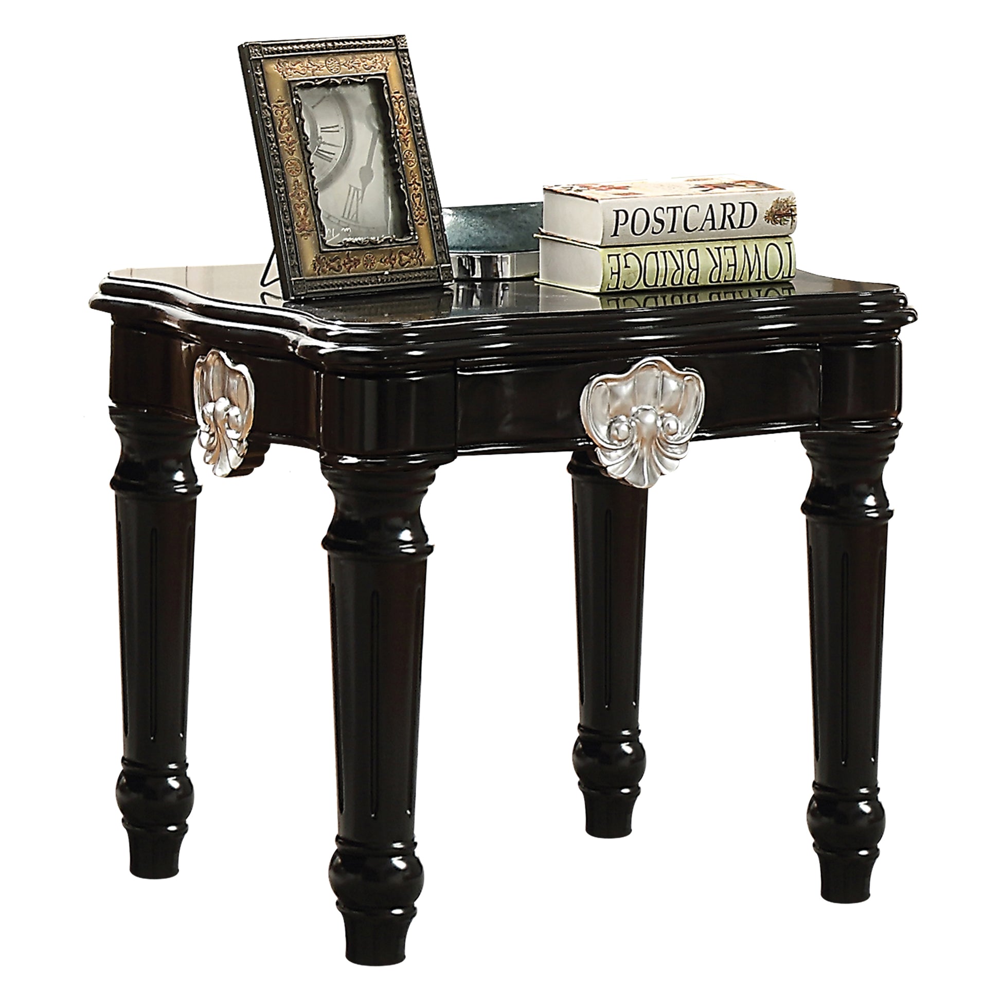 Ornate black end table with carved silver accents and a decorative clock