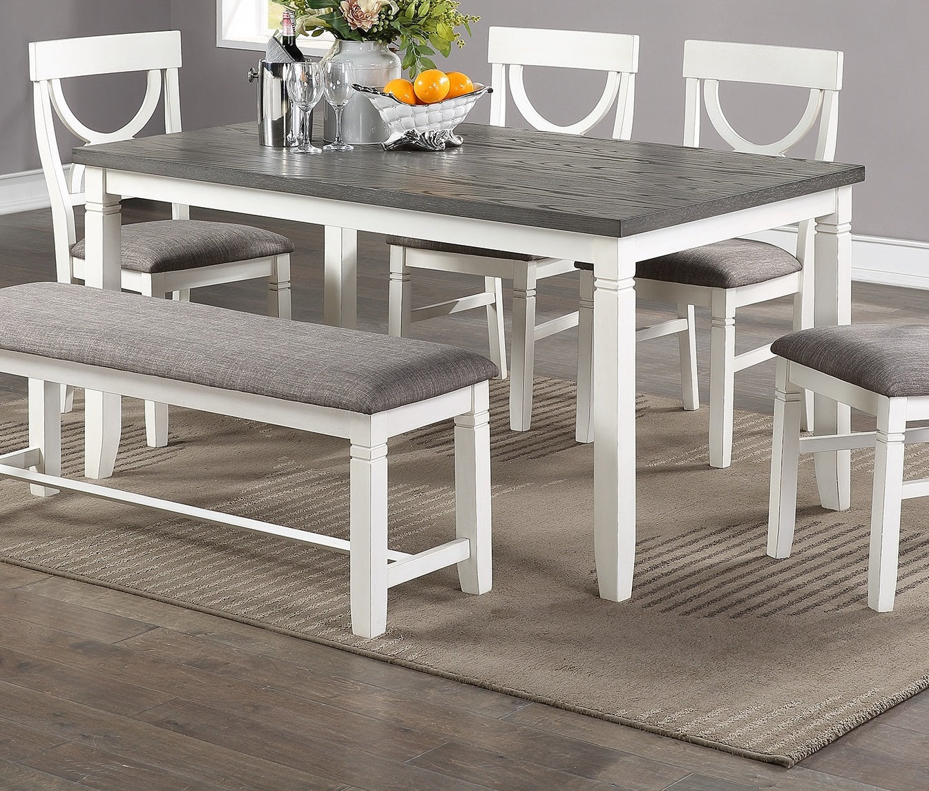 Gray and white dining table set with upholstered bench for versatile seating