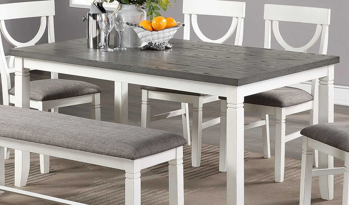 Farmhouse dining table with distressed gray wood top and white base upholstered bench