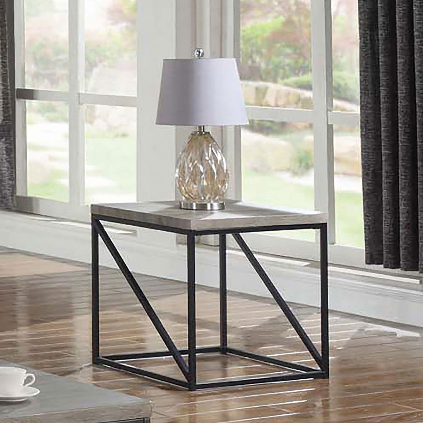 Modern grey wood end table with black metal frame and clear glass lamp