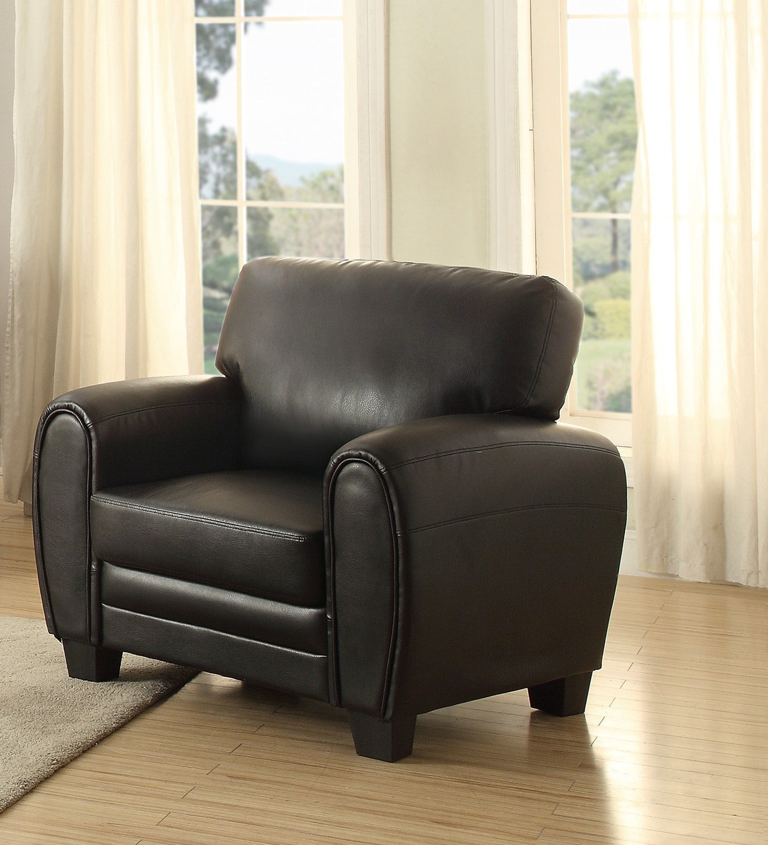 Black faux leather armchair with plush cushioning and rolled arms perfect accent chair