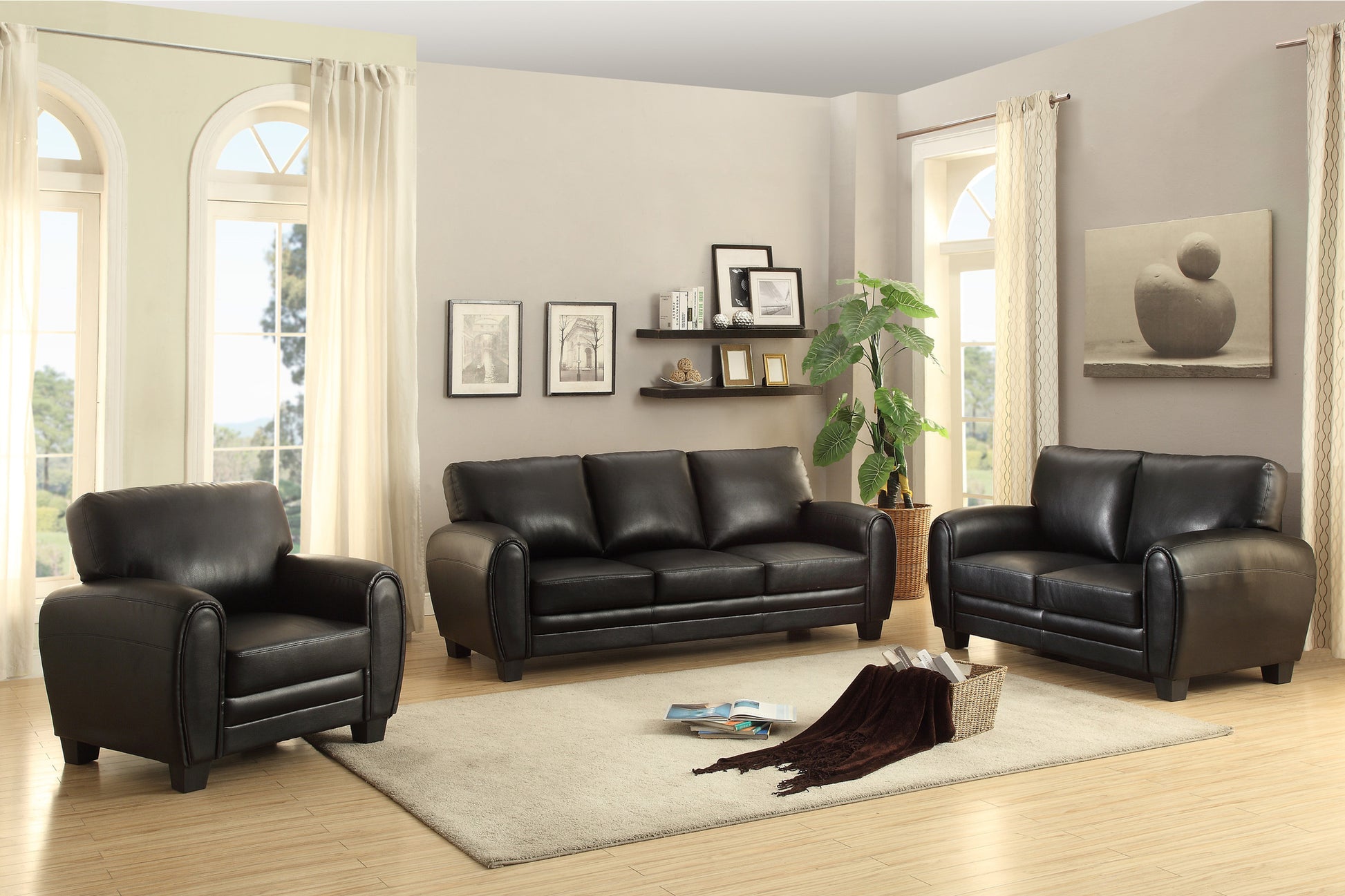 Black leather sofa set with plush cushions and padded arms Ideal living room furniture