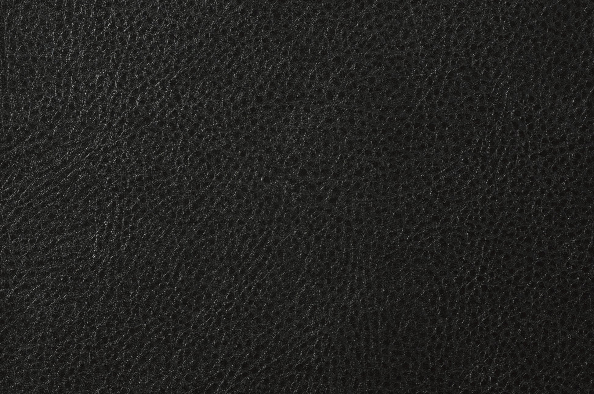 Closeup of a black leather texture with a subtle grain pattern perfect for upholstery or fashion