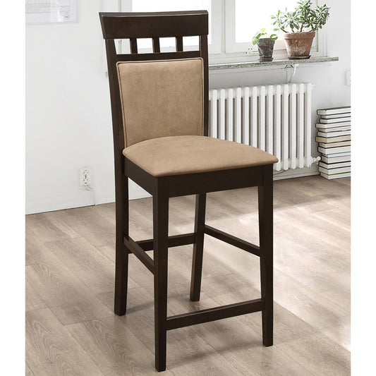 Dark wood counter height stool with tan upholstered seat and back