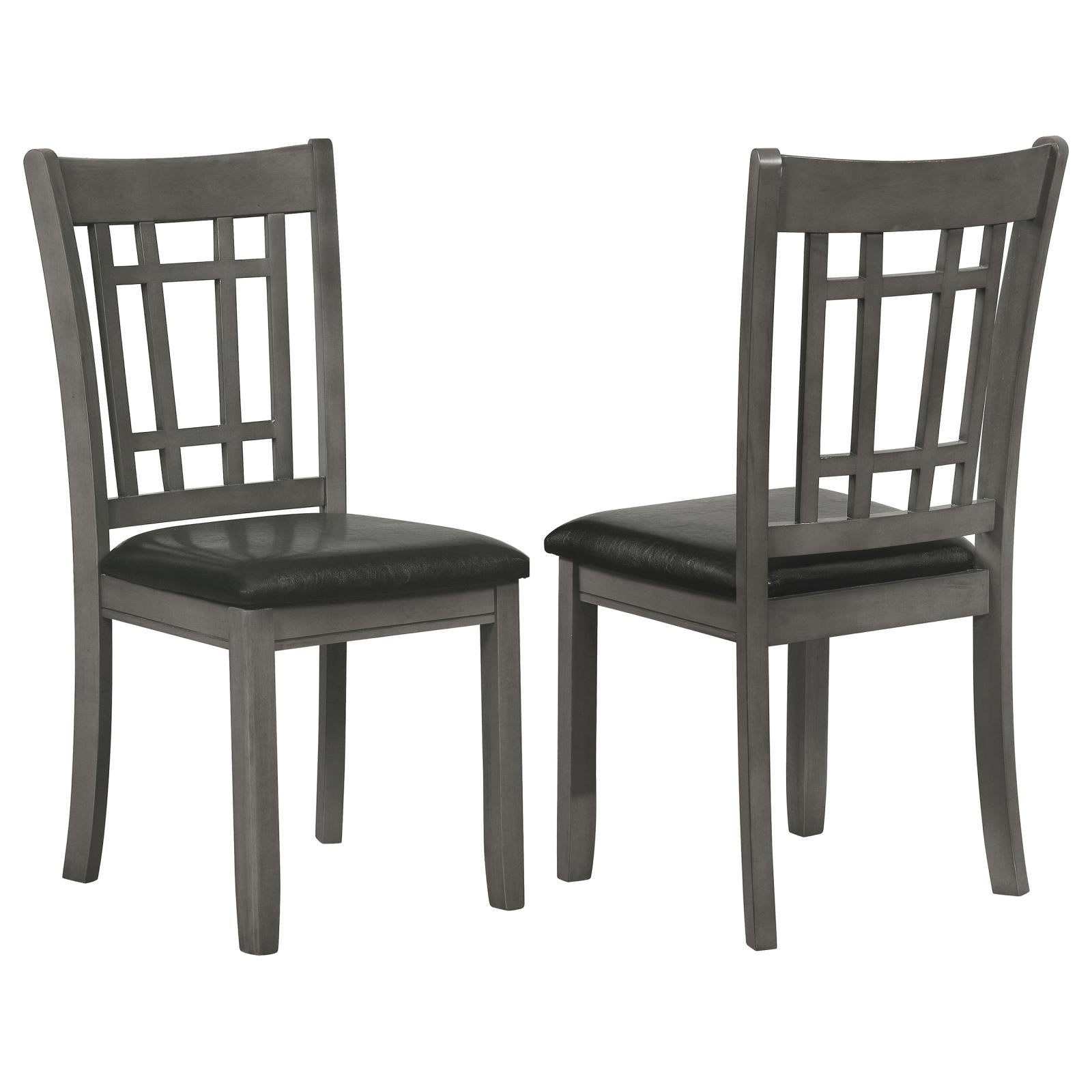Two grey wooden dining chairs with black faux leather seats and slat back design
