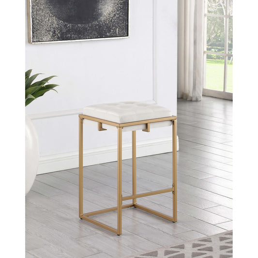 Gold frame bar stool with tufted white faux leather seat for a modern kitchen