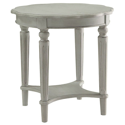 Distressed gray wood oval side table with carved legs and lower shelf
