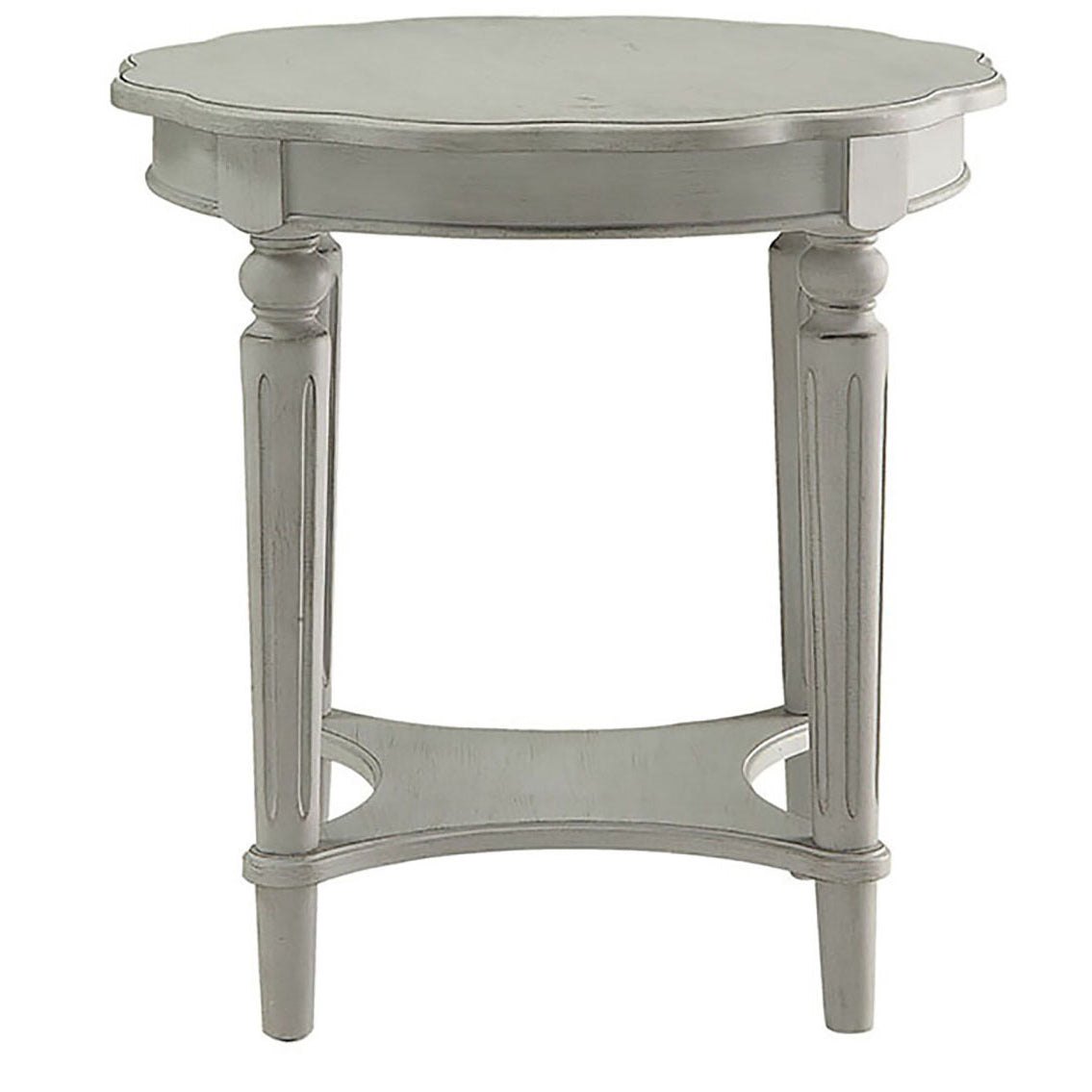 Ornate carved accent table in antique white with tiered legs and decorative shelf