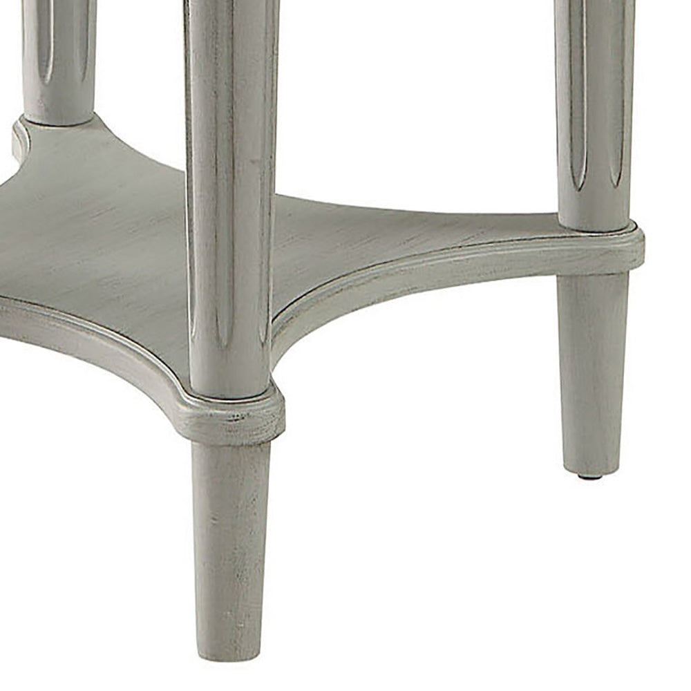 Light gray distressed wood accent table leg detail with carved accents