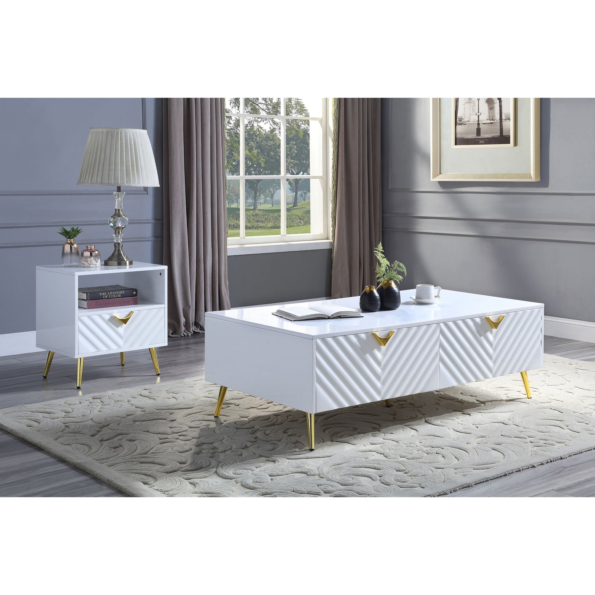 White highgloss coffee table with gold accents and chevron drawers