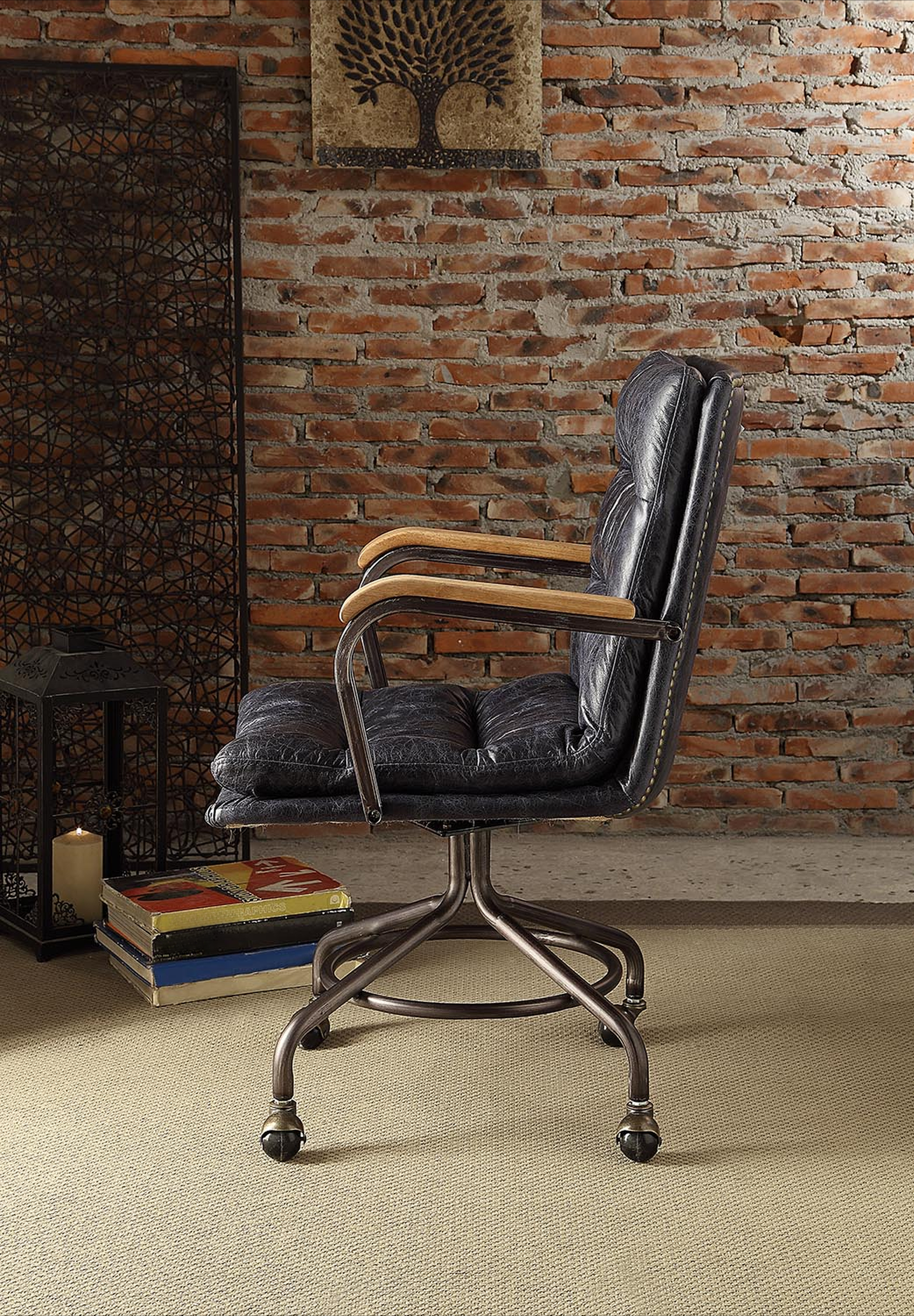 Dark blue tufted leather office chair with wood armrests and metal base