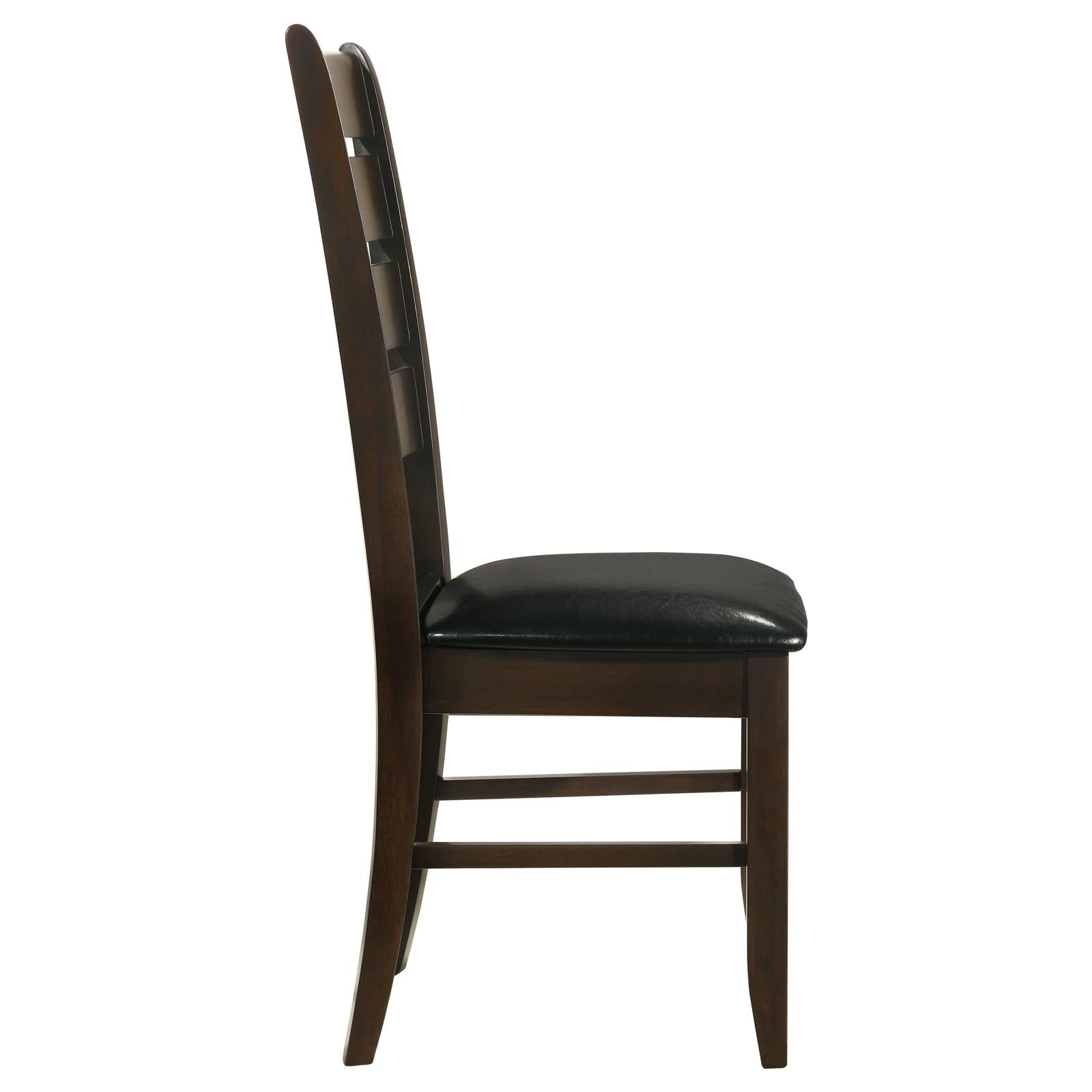 Side view of dark wood dining chair with black faux leather seat