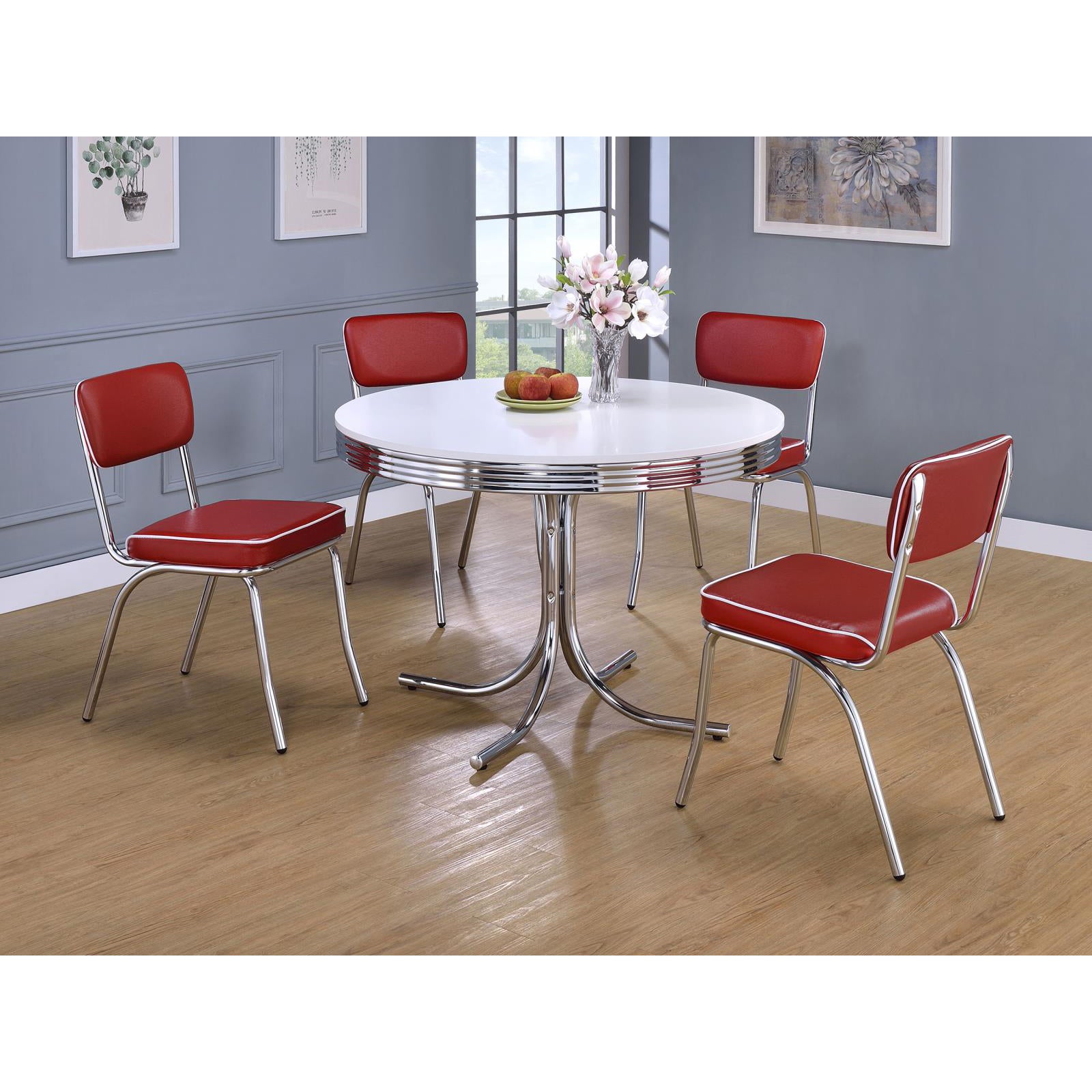 Retro diner table with four red vinyl chairs and chrome accents