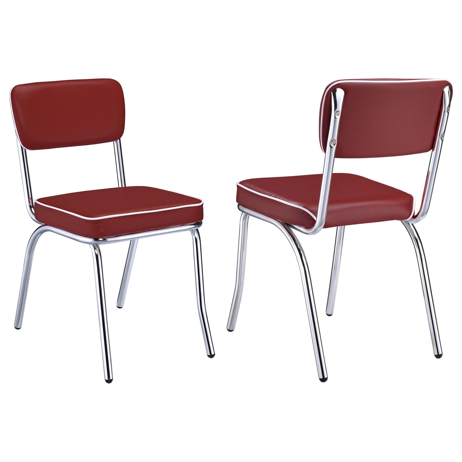 Two red vinyl retro diner chairs with white piping and chrome legs