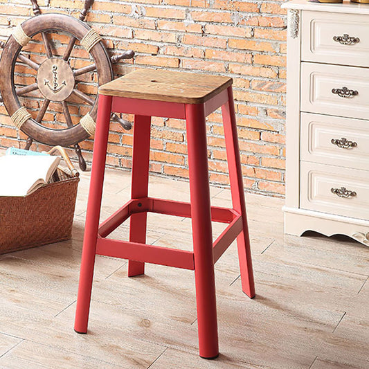 Red metal bar stool with a wooden seat for kitchen island seating