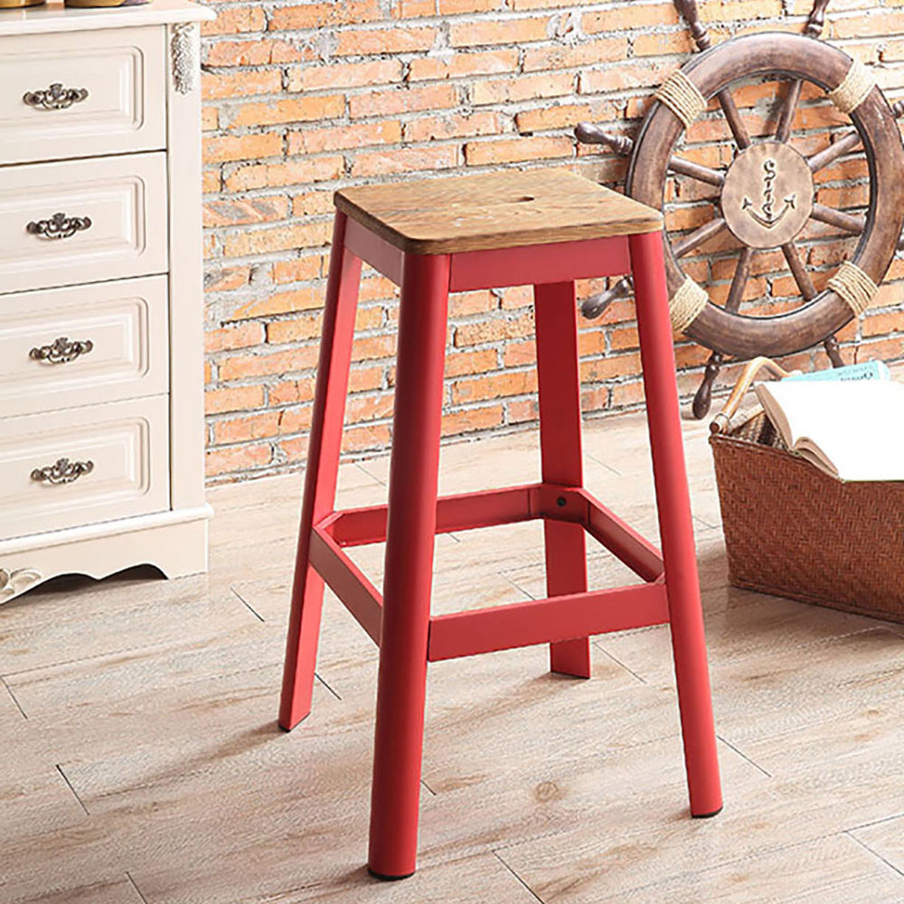 Red metal bar stool with distressed wooden seat for industrial kitchens