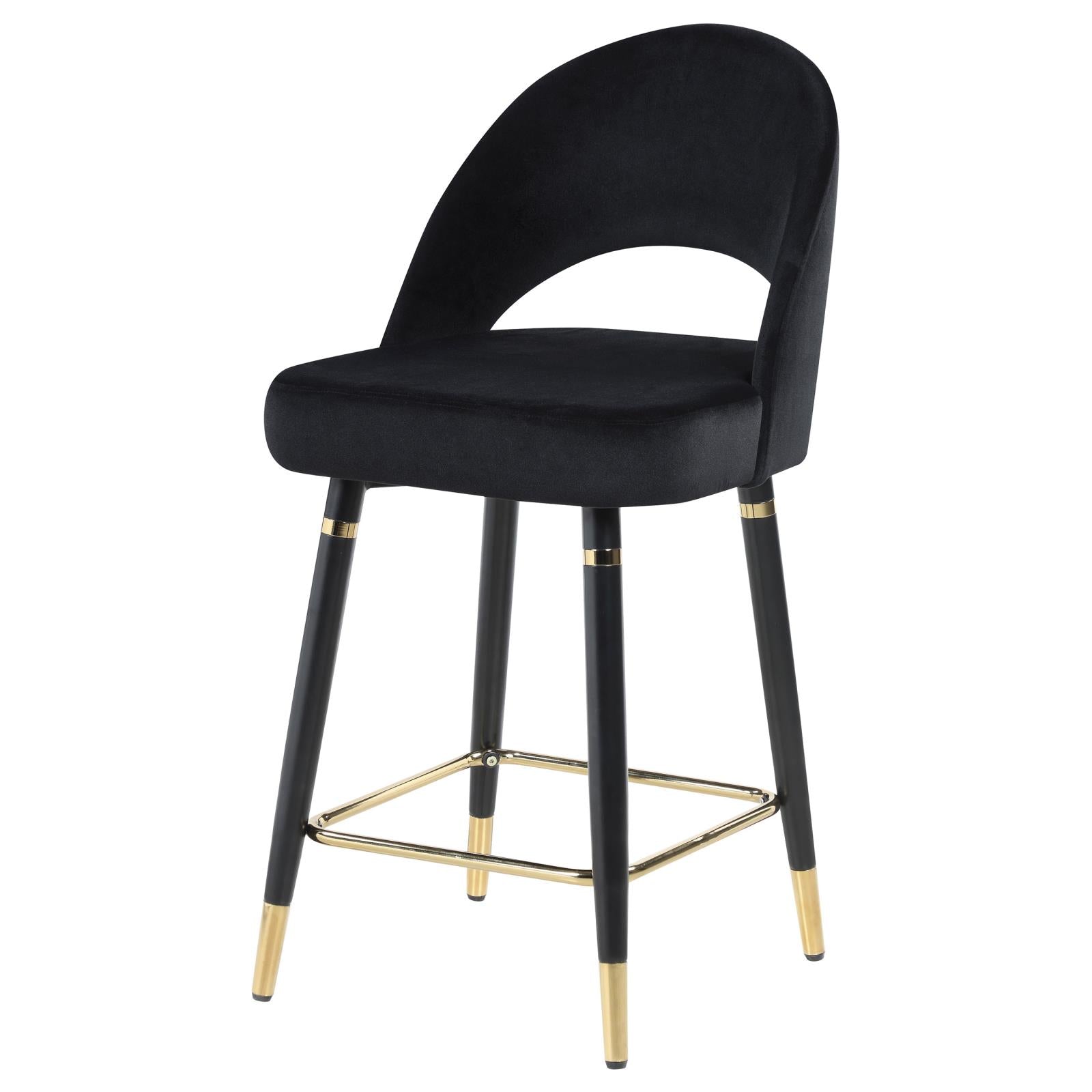 Black velvet bar stool with curved back and gold accents on legs