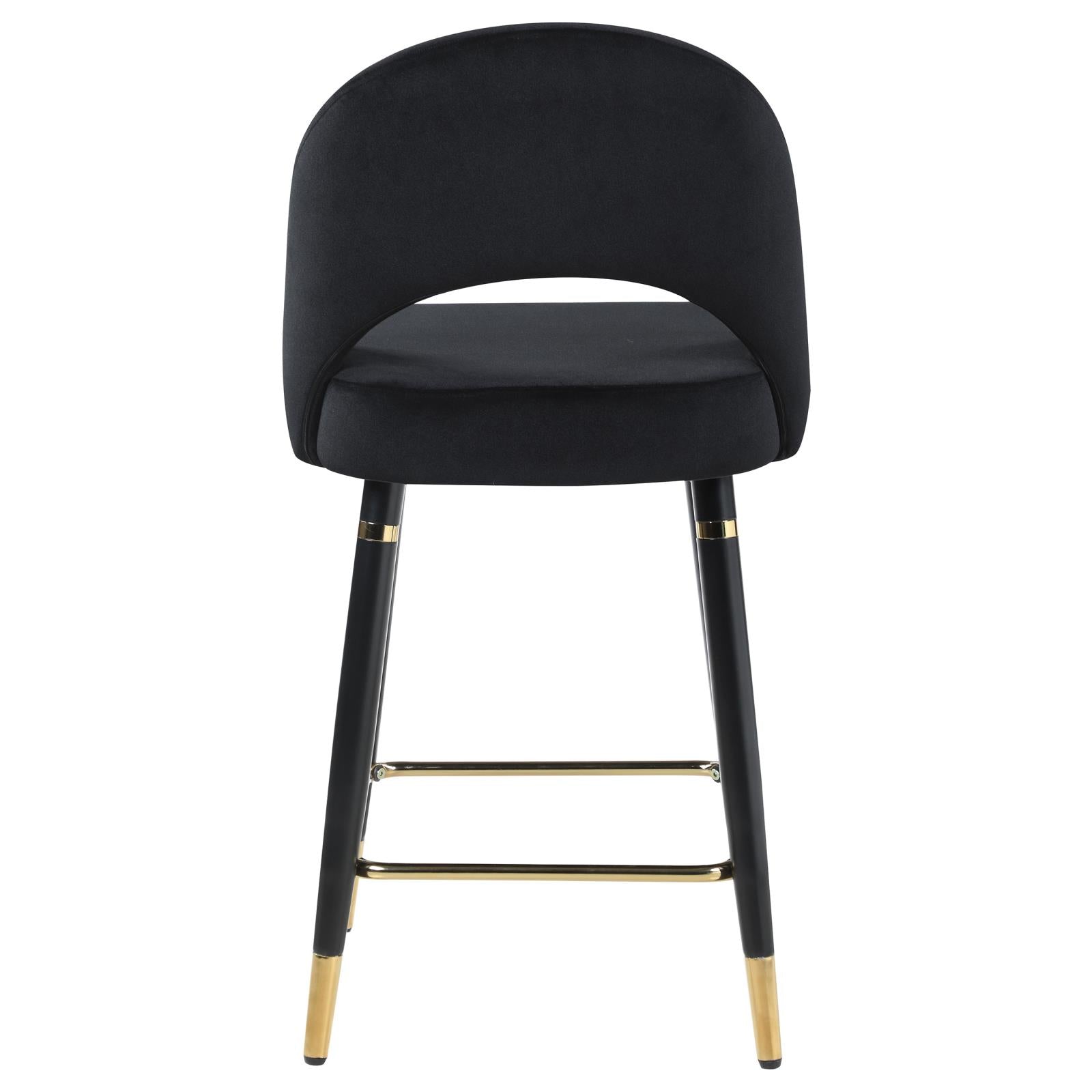 Black velvet bar stool with curved back and gold accents for modern kitchens
