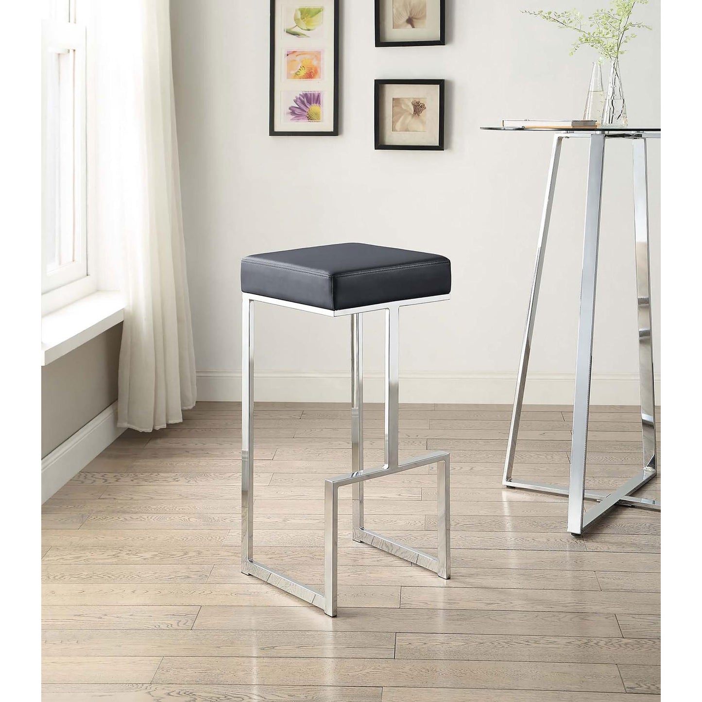 Sleek black faux leather bar stool with polished chrome legs for modern kitchens