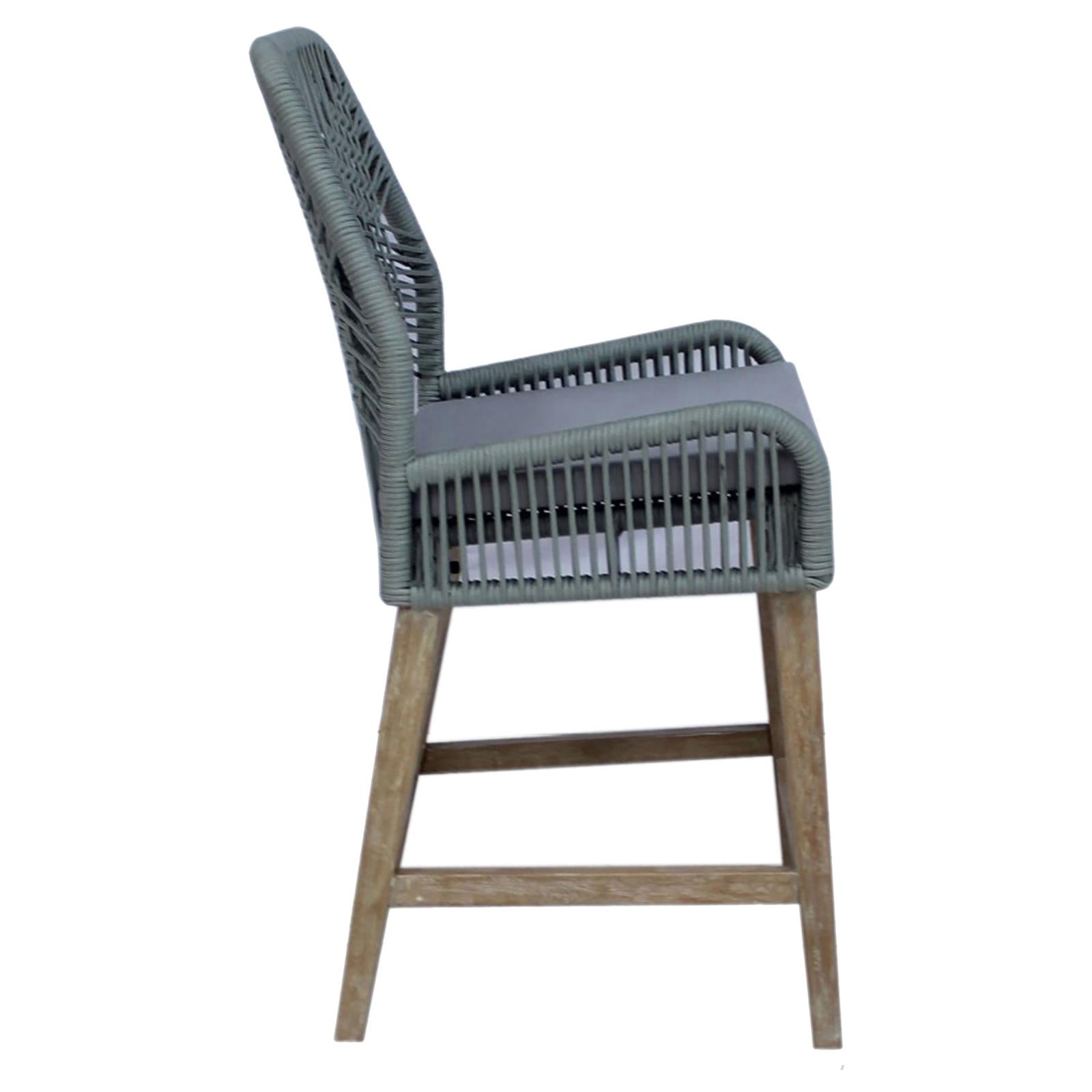 Gray woven outdoor bar stool with cushioned seat and natural wood legs