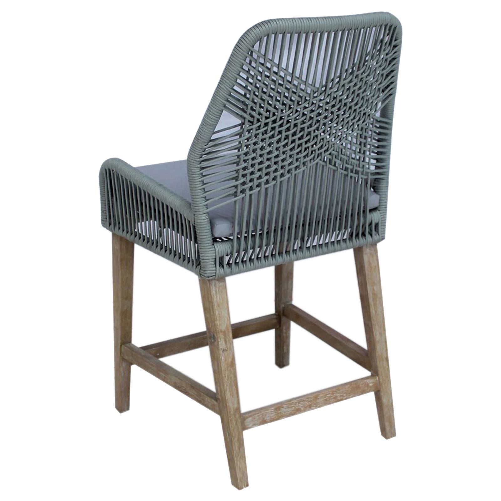 Grey woven bar stool with weathered wood legs and a comfortable cushion