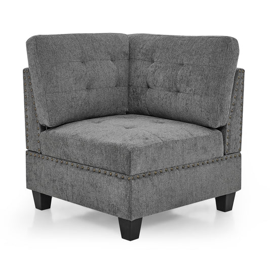 Tufted grey fabric corner chair with antique brass nailhead trim and dark wood legs