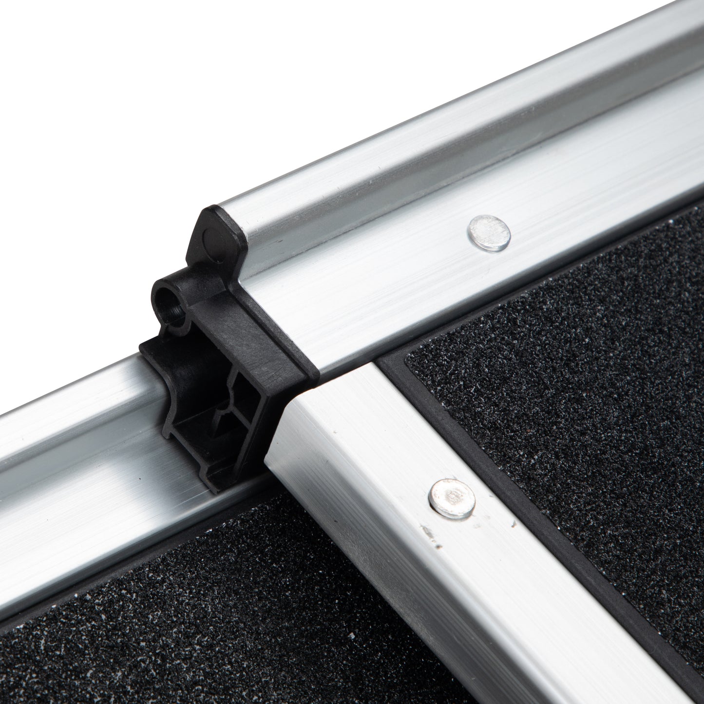 Closeup of aluminum ramp edge with black nonslip surface and connector